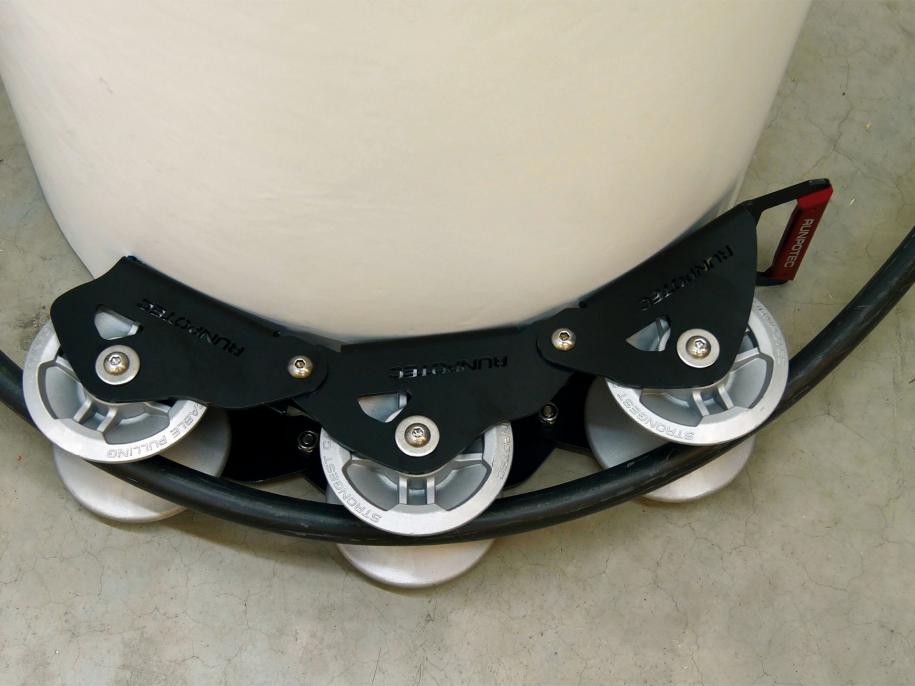 The Runpotec cable guide roller - 3 part - can be used for pulling cables gently around corners with the least possible resistance - example picture showing SWA cable running around a concrete post 