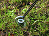 Green Powder coated Ground anchor by RiggFix in the ground
